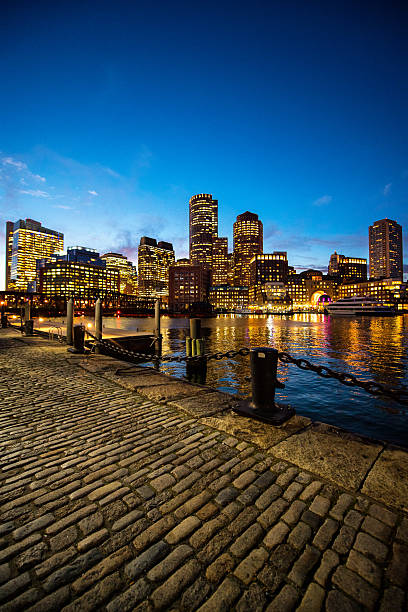 Boston skyscrapers at night View from the dock on skyscrapers in Boston, USA after sunset. boston skyline night skyscraper stock pictures, royalty-free photos & images