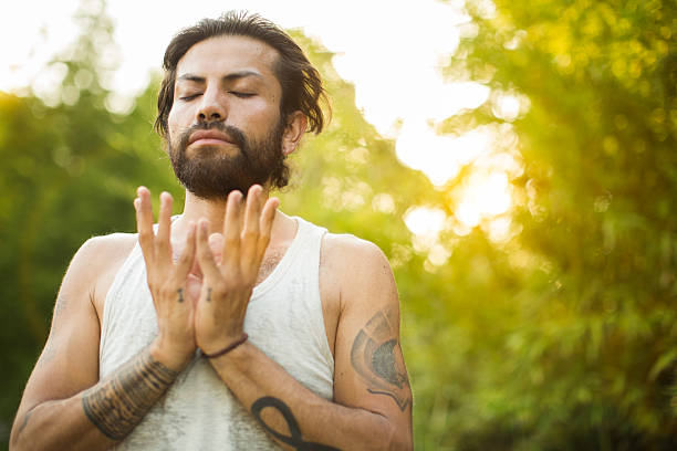 istock Young man practicing yoga in the park. 623062334