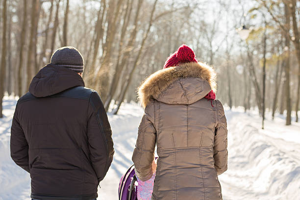 istock parents carry the baby in a stroller through the snow. 623063220