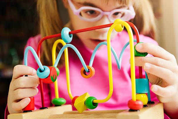 istock Child playing with wooden roller coaster bead toy 623064450