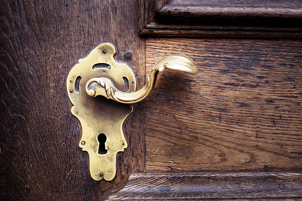 istock Ancient golden keyhole for security on wooden door 623066402