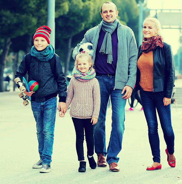 istock Spouses with children posing in autumn park 623069540