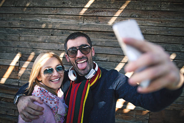 istock happy couple making selfie outdoor 623070924