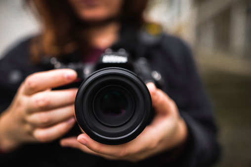 A young woman using a DSLR camera