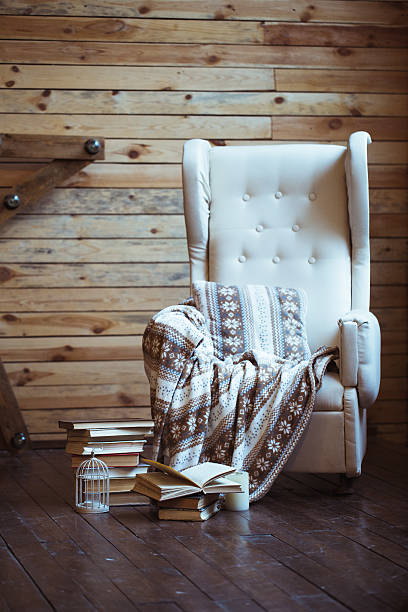 istock Stack of books with warm plaid on chair 623087718