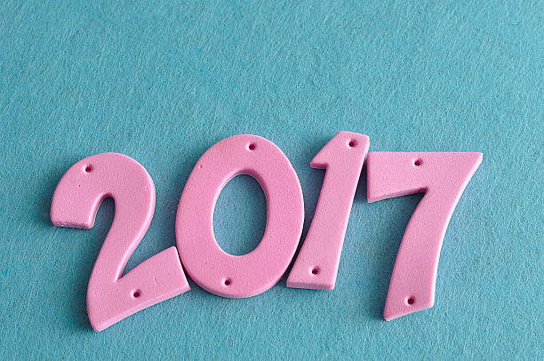 istock 2017 in pink numbers isolated against a blue background 623089248