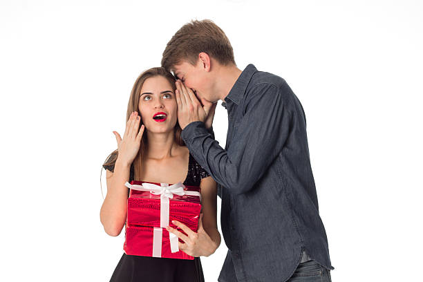 istock young couple with gift in hands 623090164