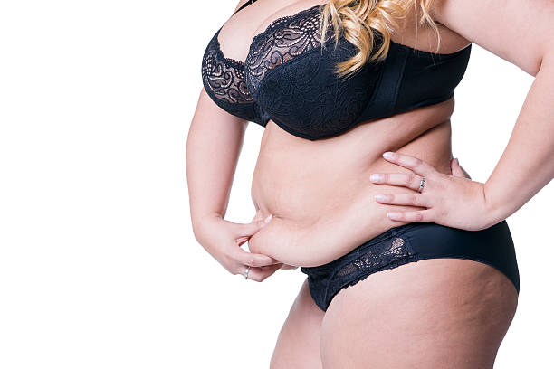 corpo femminile in sovrappeso, donna grassa con stomaco flaccido isolato - fulness foto e immagini stock