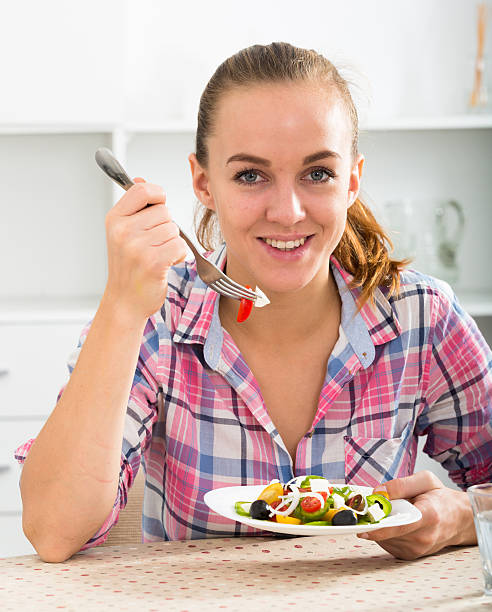 istock Girl eating salad 623090760