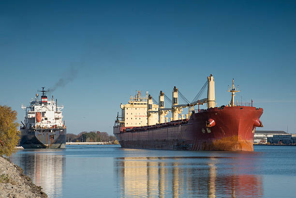 Two lake freighters passing on the Welland Canal Two lake freighters passing on the exit from Lock 1 while navigating  the Welland Canal, great lakes stock pictures, royalty-free photos & images