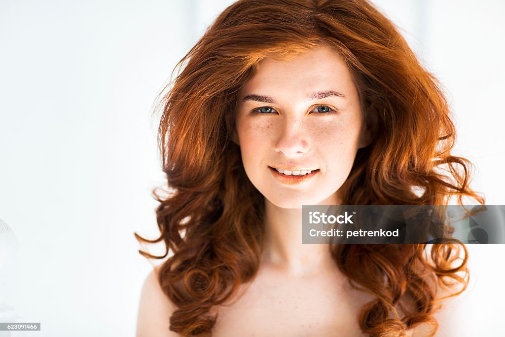 Beautiful young redhead woman with freckles portrait Beautiful young redhead woman with freckles portrait on the white background Adult Stock Photo