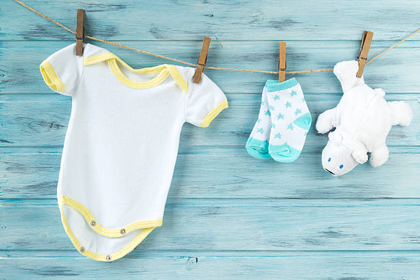 istock Baby clothes and white bear toy on a clothesline 623092126