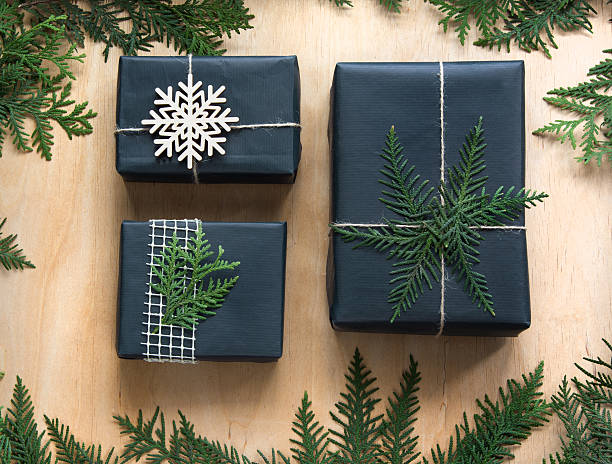 istock Christmas gift box wrapped in black paper on wooden surface. 623095546