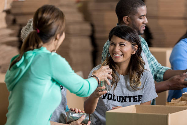 istock Cheerful volunteers pack boxes at food bank 623095736