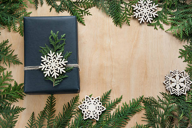 istock Christmas gift box wrapped in black paper on wooden surface. 623096008