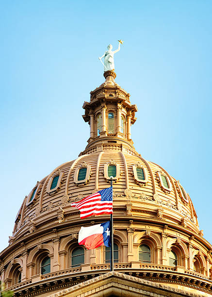 istock Austin Texas Capitol dome with American and Texan flags 623097556