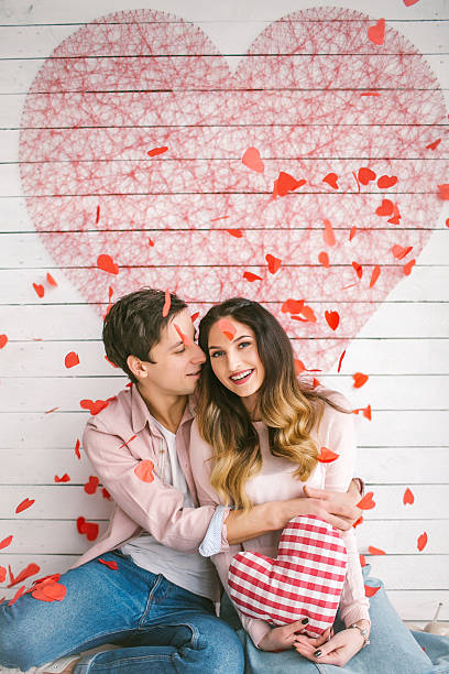 istock Young couple in love embracing under confetti in decorated studi 623099294