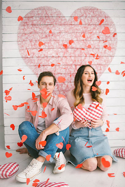 istock Young couple in love embracing under confetti in decorated studi 623099800