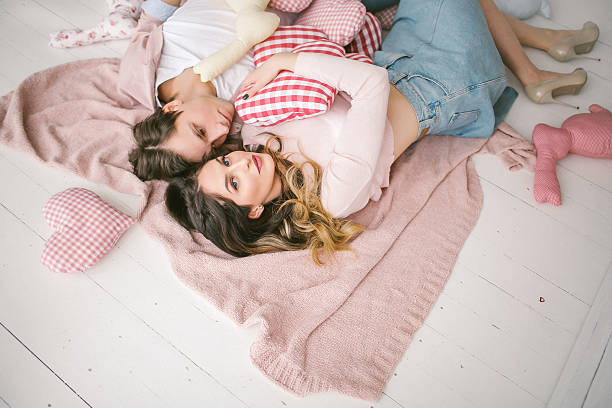 istock Happy couple in love lying on floor in studio 623101522