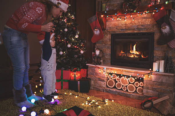 istock Mother and son by a fireplace on Christmas night 623102580