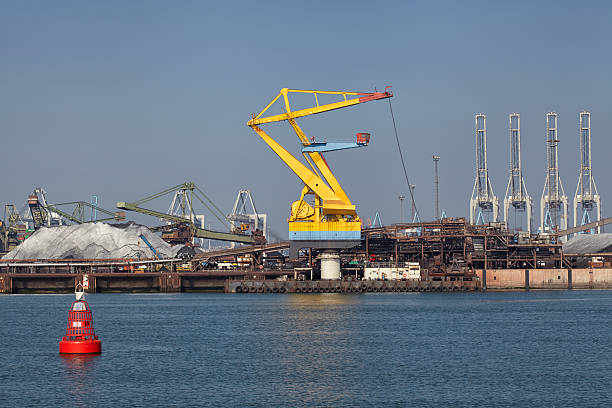 istock Port cargo crane and sand over blue sky background 623103692