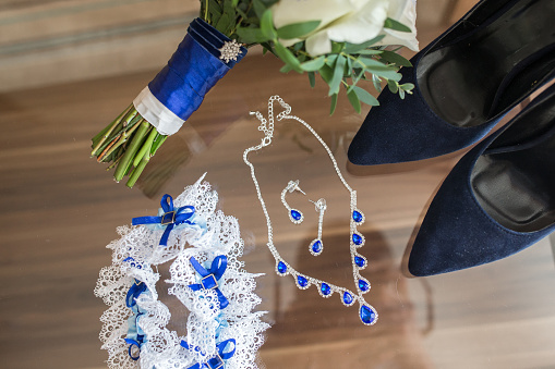 Wedding accessories: perfume bottle and a garter