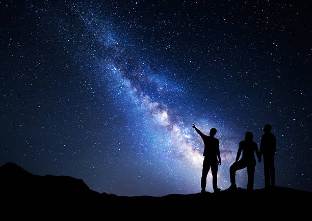 istock Colorful Milky Way with silhouette of a standing man 623105288