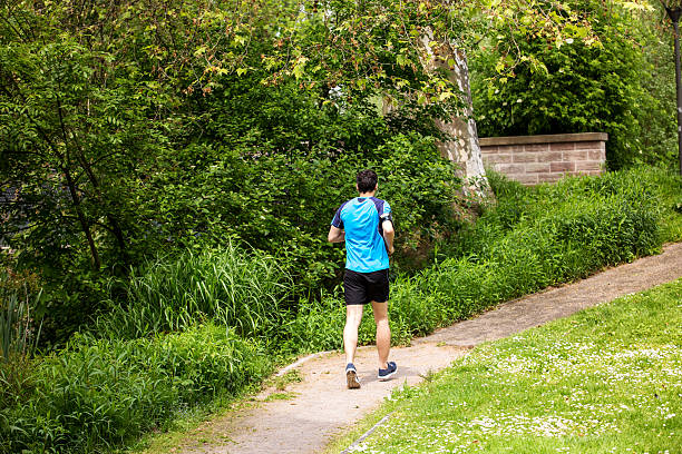 istock Healthy running runner man workout in a city park 623108166