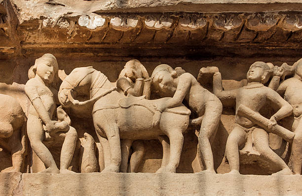 Intimate life of ancient people, Khajuraho temple, India. UNESCO site Intimate life of ancient people on stone relief on wall of Khajuraho temple, India. UNESCO Heritage site, built between 950 and 1150 in India, belong to Hinduism and Jainism. animal macho stock pictures, royalty-free photos & images