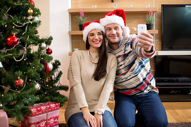 istock Couple in love doing selfi beside the Christmas tree 623110746