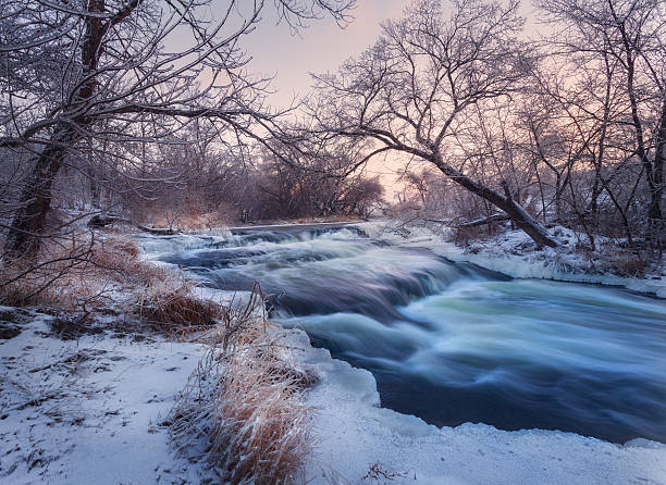 istock Winter landscape with snowy trees, beautiful frozen river at sun 623110878