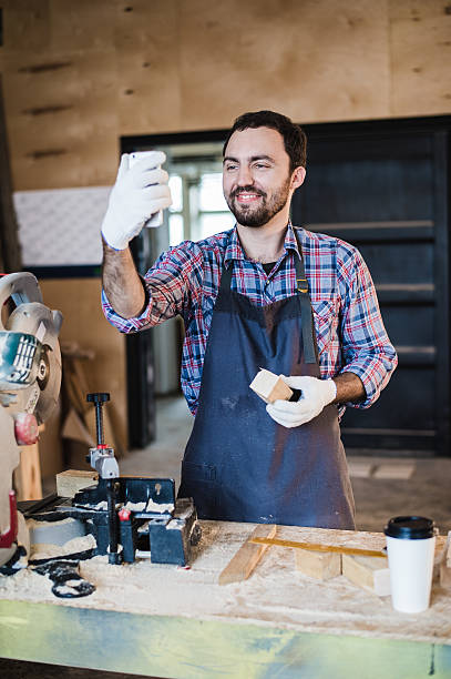 istock Carpenter taking a selfie with miter saw at his work 623111010
