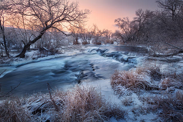 istock Winter landscape with snowy trees, beautiful frozen river at sun 623111124