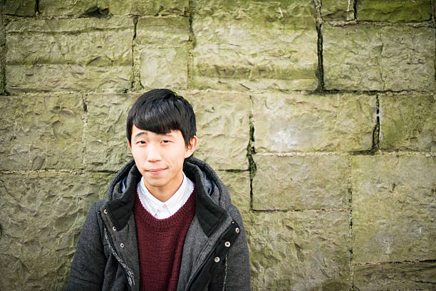 istock Handsome Japanese young man against a wall 623111232