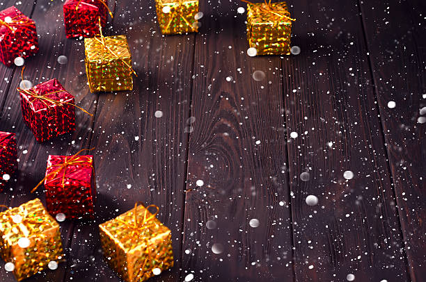 istock Christmas gift boxes on wooden table with snow. 623112360