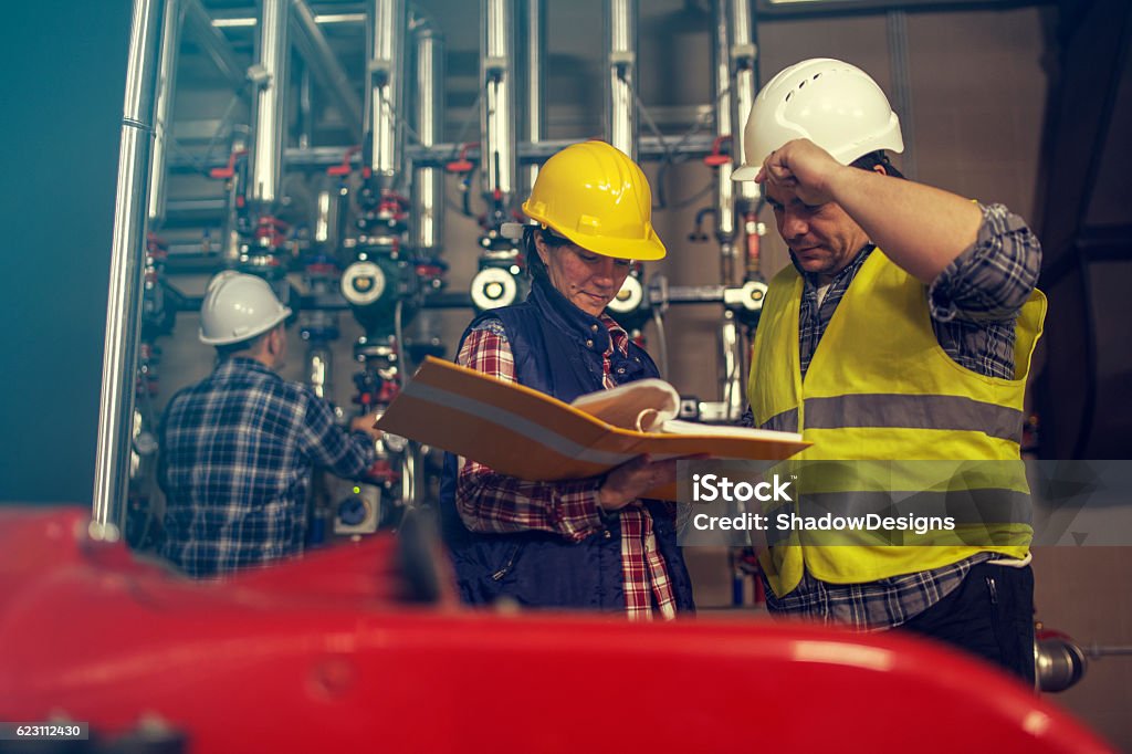 Technicians working in factory or utility Technicians / engineers working in factory or utility Air Duct Stock Photo