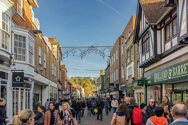 Winchester high street on a busy weekend afternoon Winchester, United Kingdom - November 13, 2016: Tourists and pedestrians walking through the High Street in Winchester. clad stock pictures, royalty-free photos & images