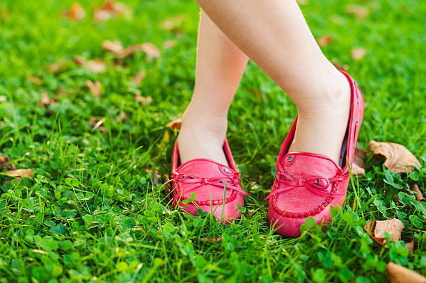 istock Red moccasins on child's feet 623116342