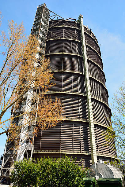 An iconic historic water tower in Berlin, Germany, surrounded by lush green trees and a beautiful sky, capturing the essence of architectural heritage.Wasserturm, Berlin, Prenzlauer Berg
