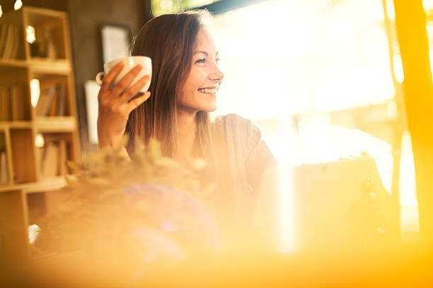 istock Young girl having a cup of coffee at a cafe 623118468