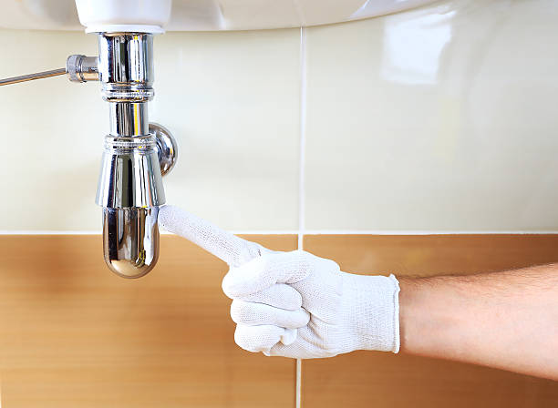 istock Plumber showing problem area of sink 623118694