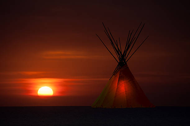 istock Teepee camp and gold, dark,  sunset- light in teepees 623119836