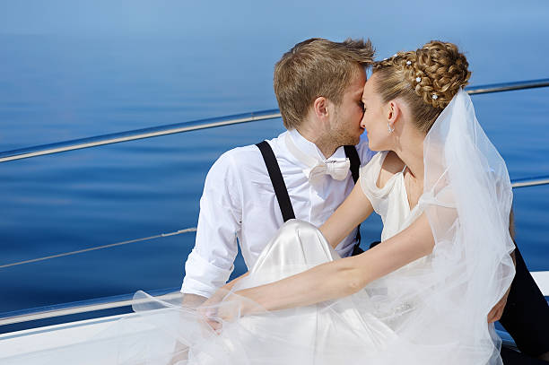 istock Happy bride and groom on a yacht 623121120