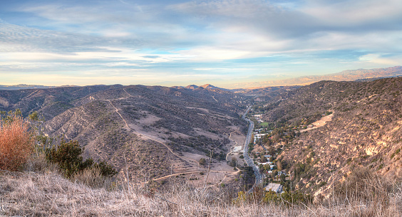 Laguna Canyon Road with Saddleback Mountains in the distance from Top of the World hiking trail in Laguna Beach at sunset