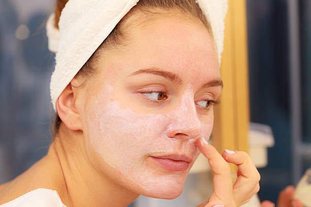 istock Woman applying mask cream on face in bathroom 623122200