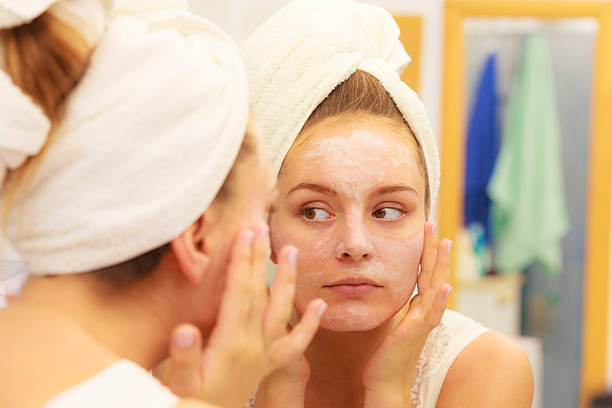 istock Woman applying mask cream on face in bathroom 623123796