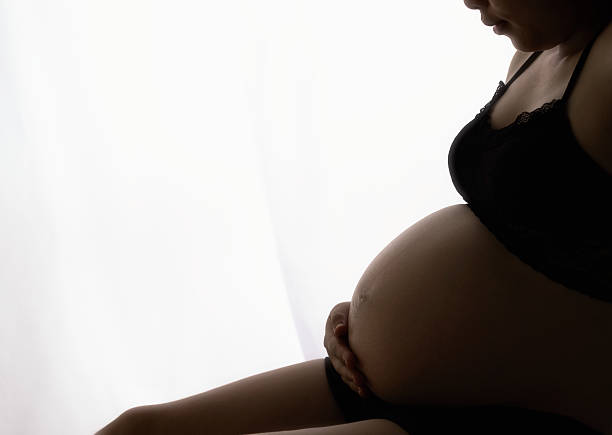 istock Belly asia pregnant woman with window light 623124142