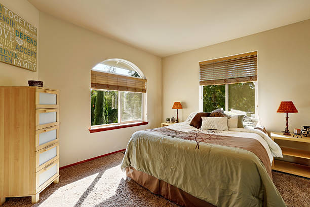 istock Bright sunny bedroom interior with modern cabinet and arched window. 623124548