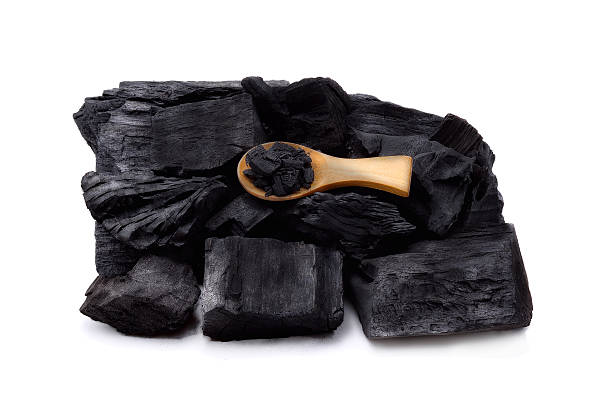 istock Natural wood charcoal isolated on white background 623124554