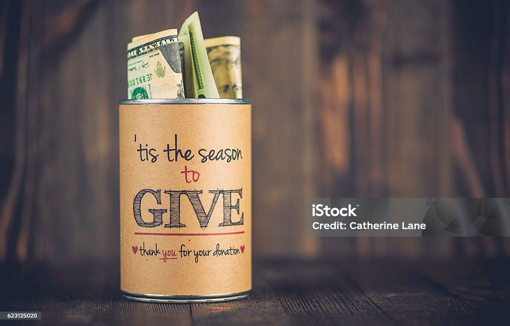 Charity collecting tin against wooden background. American holiday fundraising Giving Stock Photo